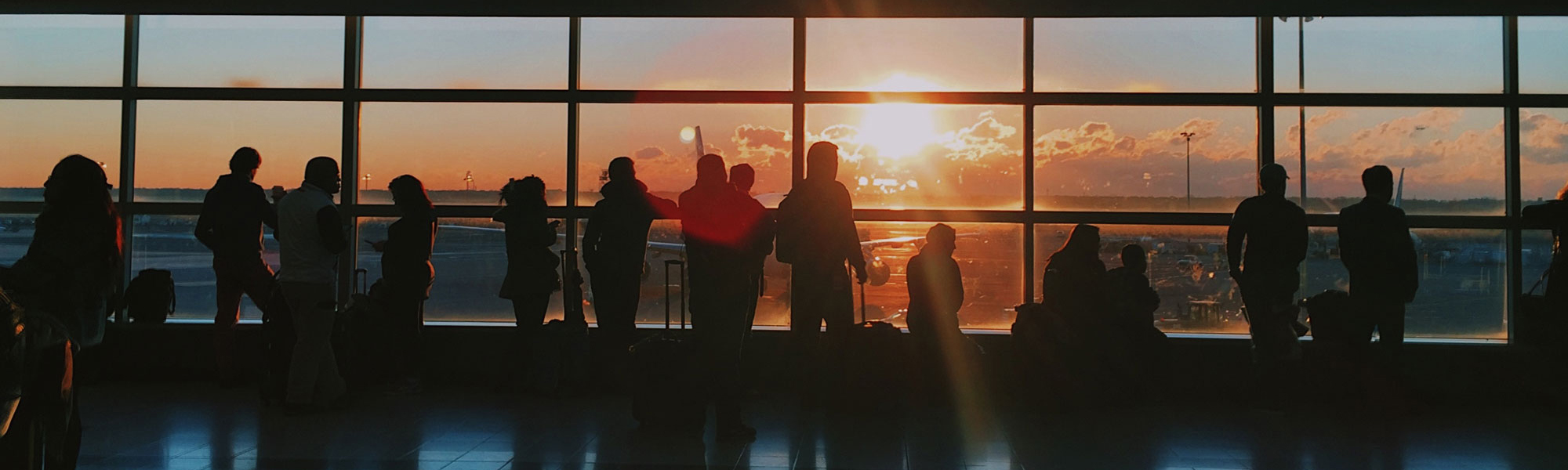 People at airport Photo by Jon Tyson on Unsplash