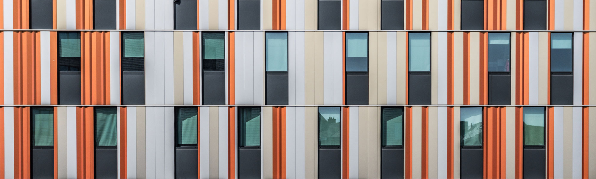 Orange window shuttters Photo by Bernard Hermant on Unsplash